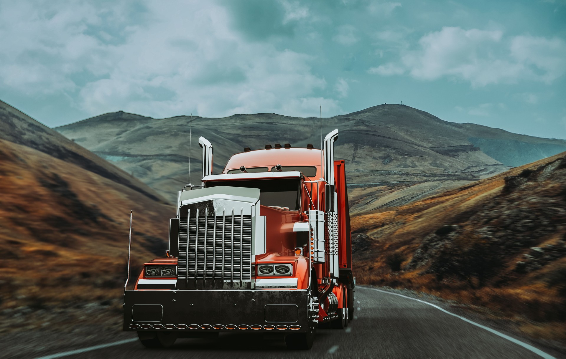 A red truck runs on a mountain road.